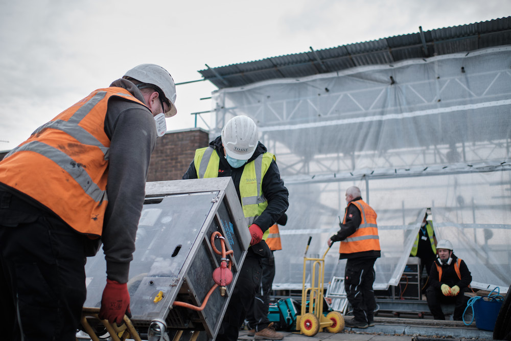 men load equipment on site